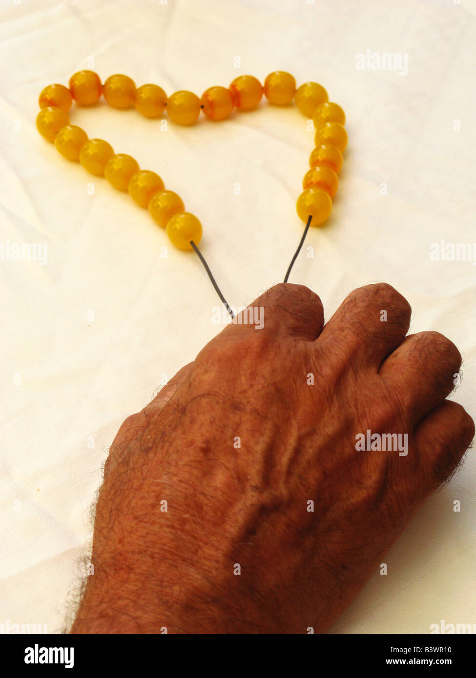 Greece Crete Male hand holding worry beads Stock Photo