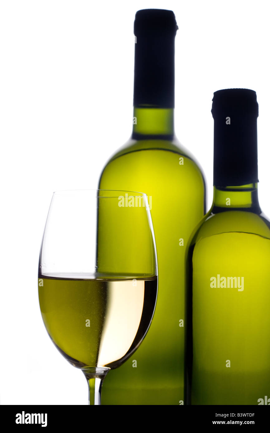 Wineglass with two wine bottles Stock Photo