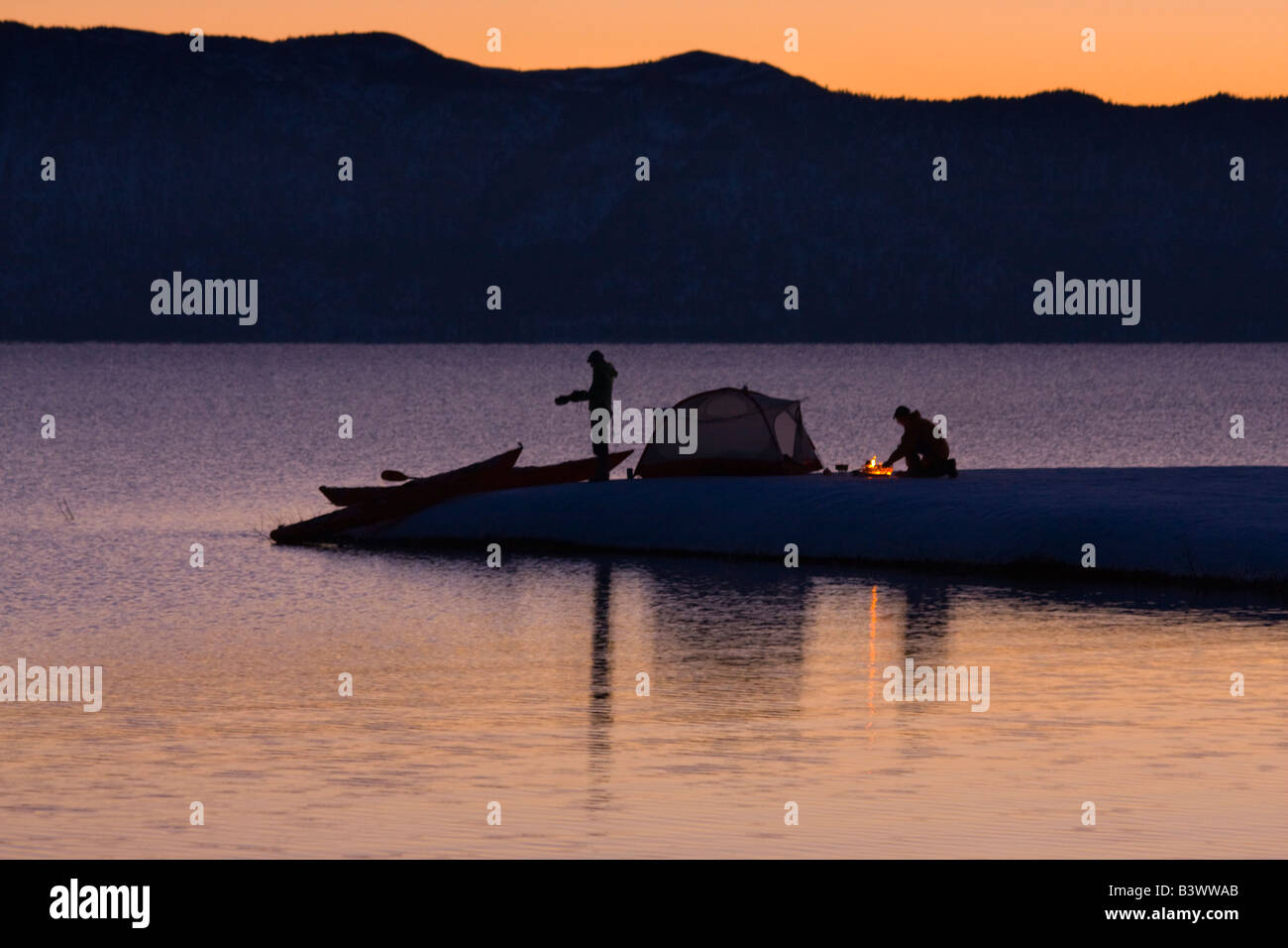 Silhouette of a man and a woman camping at the lakeside, Lake Tahoe, California, USA Stock Photo