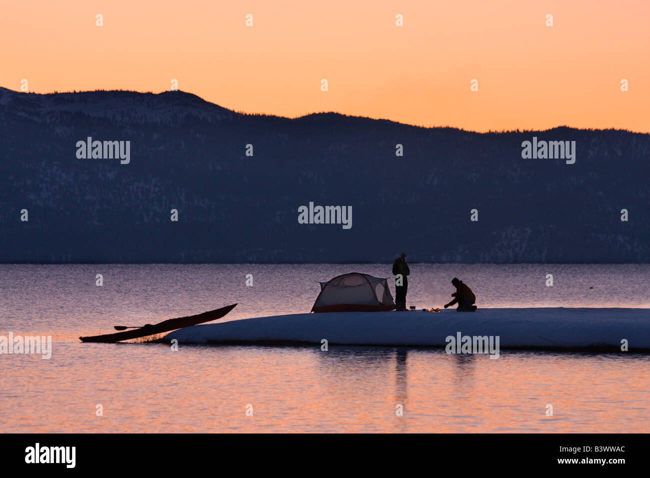 Silhouette of a man and a woman camping at the lakeside, Lake Tahoe, California, USA Stock Photo