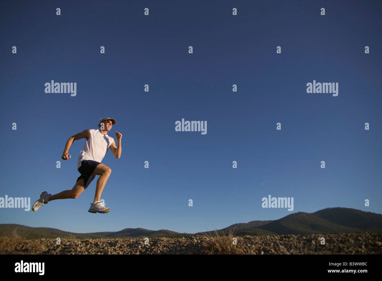 Low angle view of a man running in a field Stock Photo