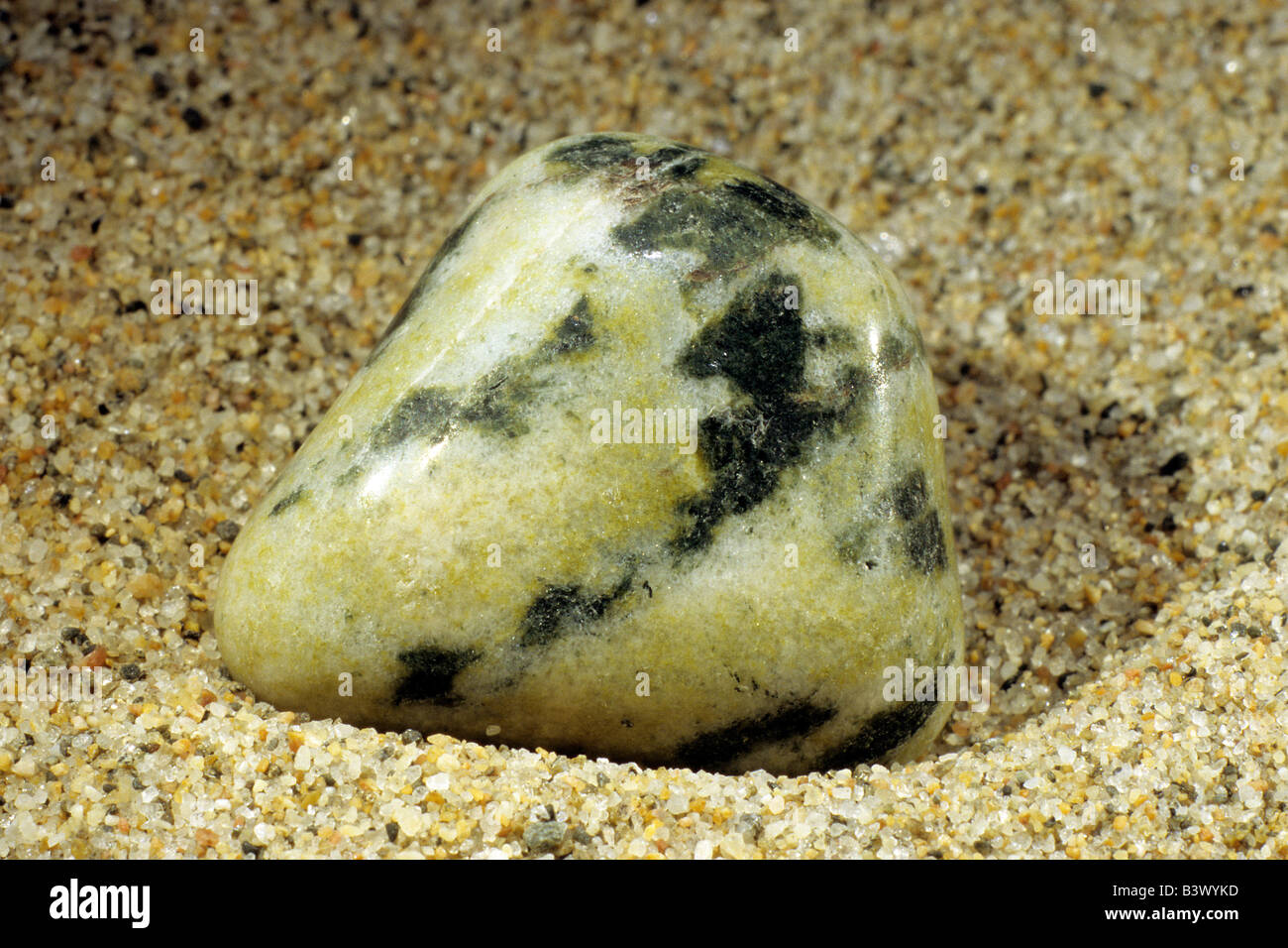 Jade, Jadeit, polished pebble on sand Stock Photo Alamy