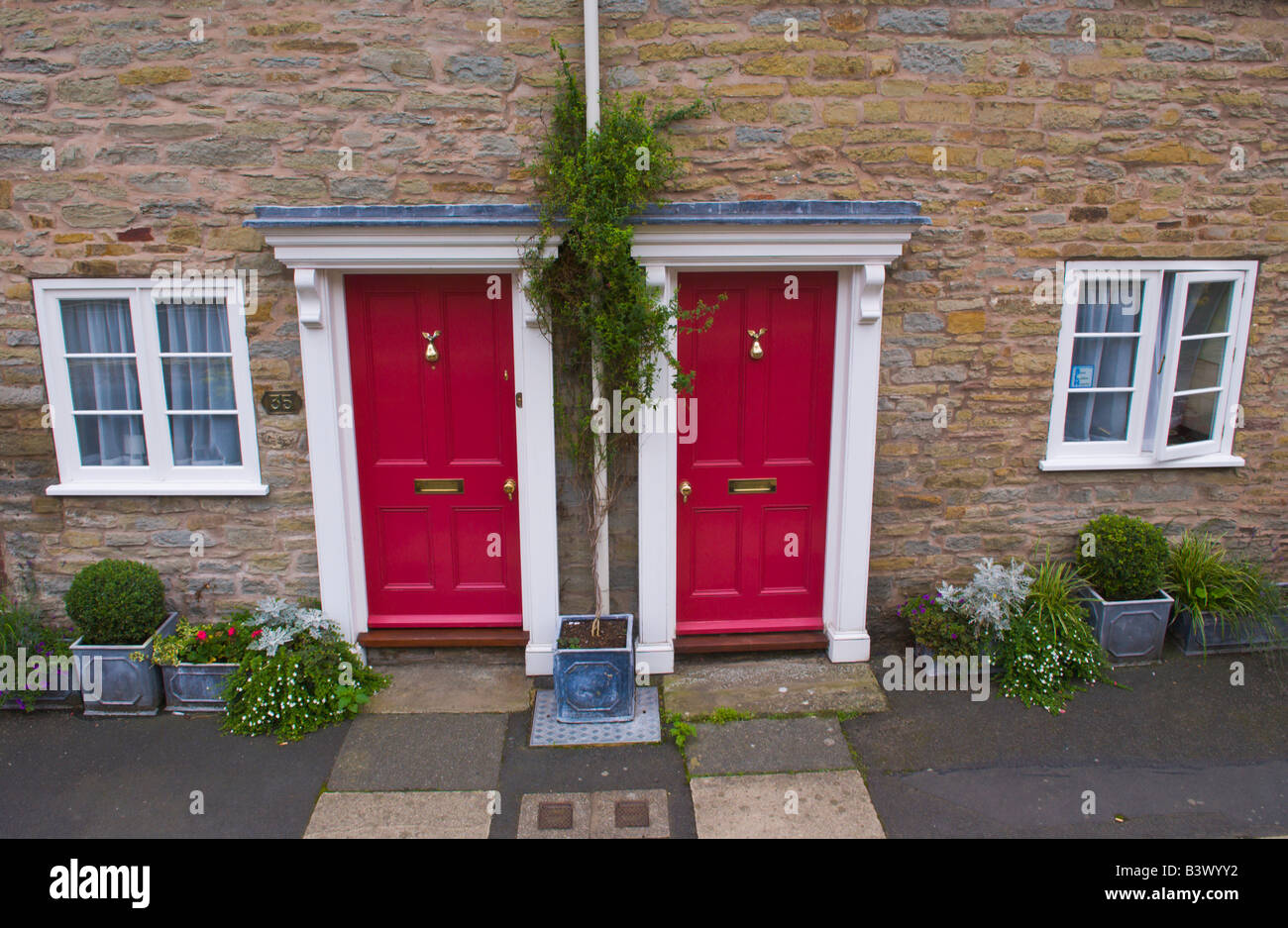 Pair of identical front doors on terraced cottages in Ludlow Shropshire England UK Stock Photo