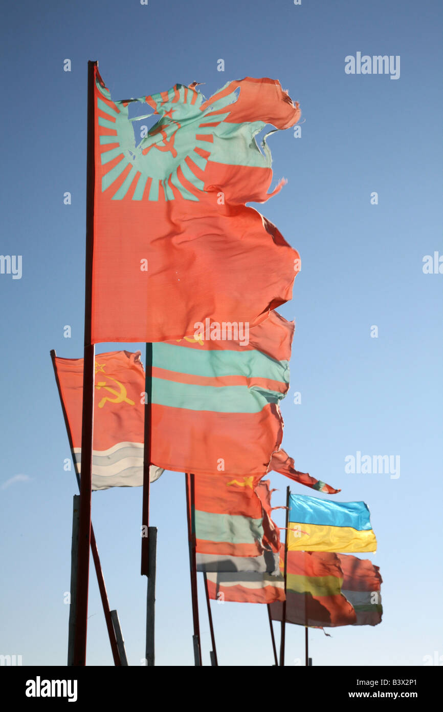 Old Soviet republics flags beside a modern Ukrainian flag waving over the pilgrim camp on the Solovetsky Islands, Russia Stock Photo