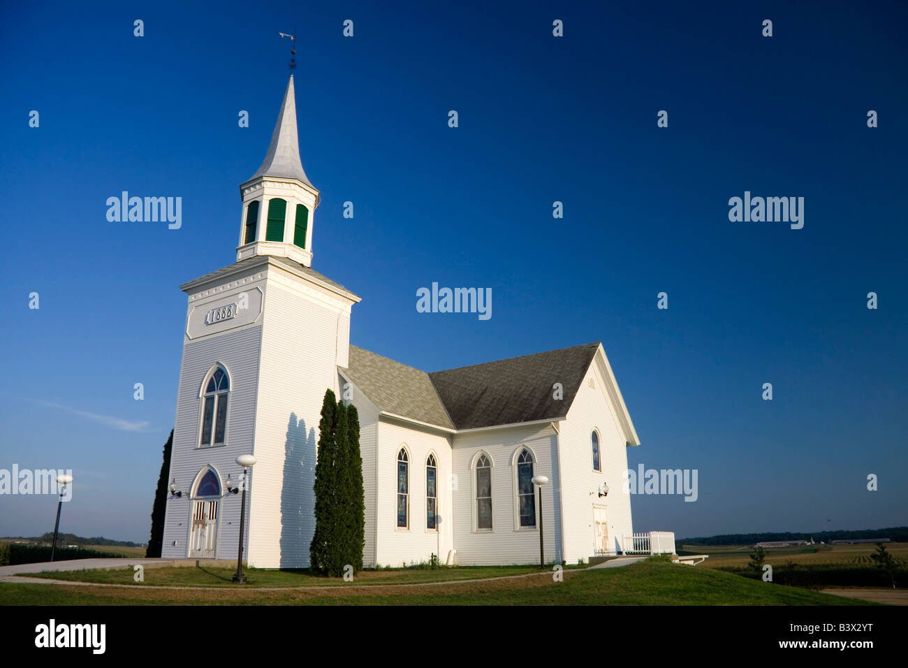 Old white church set against a dark blue sky Stock Photo - Alamy