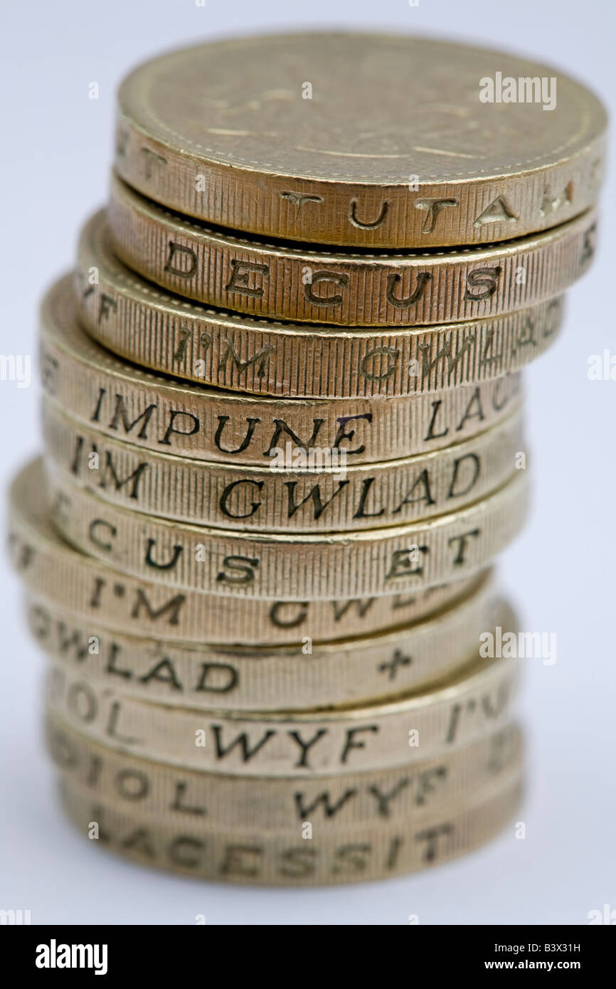 Close-up of stack or pile of old one pound coins (British currency no longer in circulation). Words in Latin & Welsh on the edges - England, UK. Stock Photo