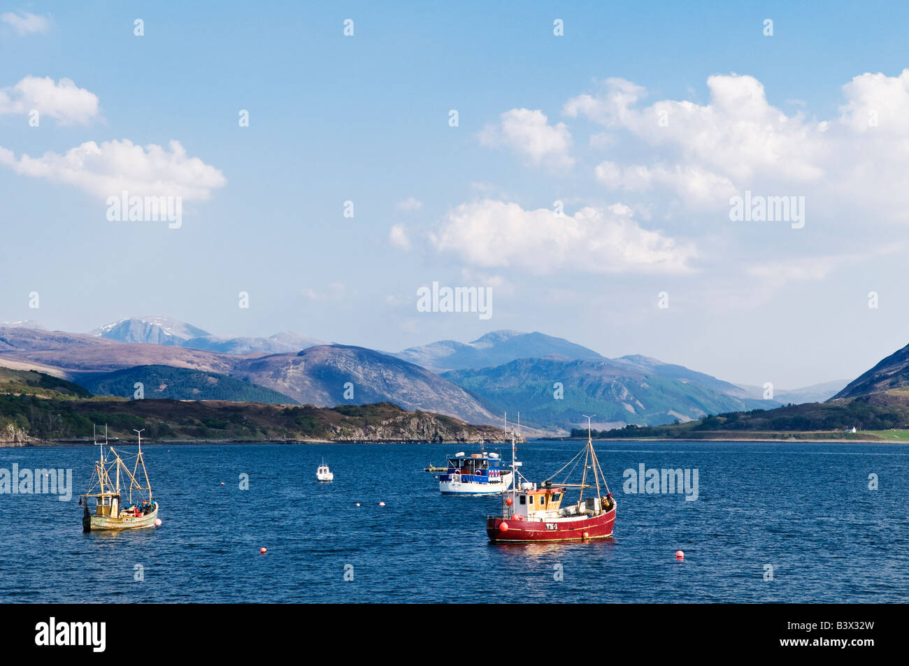 Fishing boats moored in Loch Broom on a sunny day, Ullapool, Scotland Stock Photo