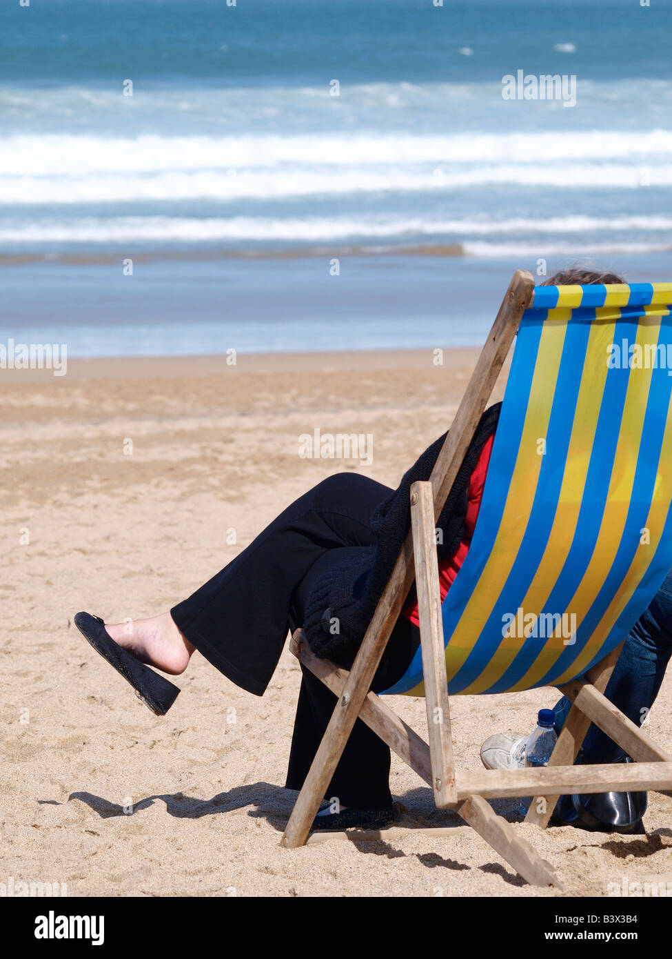 Older woman deck chair beach hi-res stock photography and images - Alamy