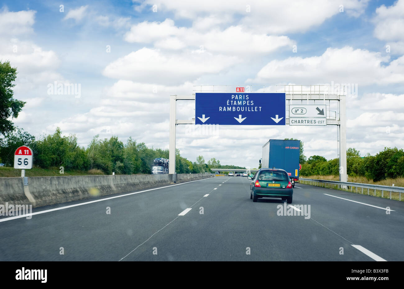 Cars and road signs on A11 highway heading to Paris, Ile-de-France, France Stock Photo