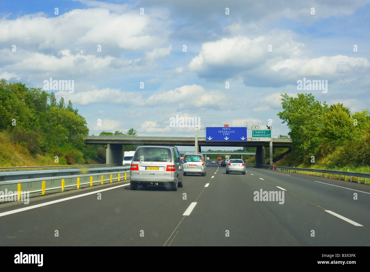 Cars and road signs on A11 highway heading to Paris, Ile-de-France, France Stock Photo