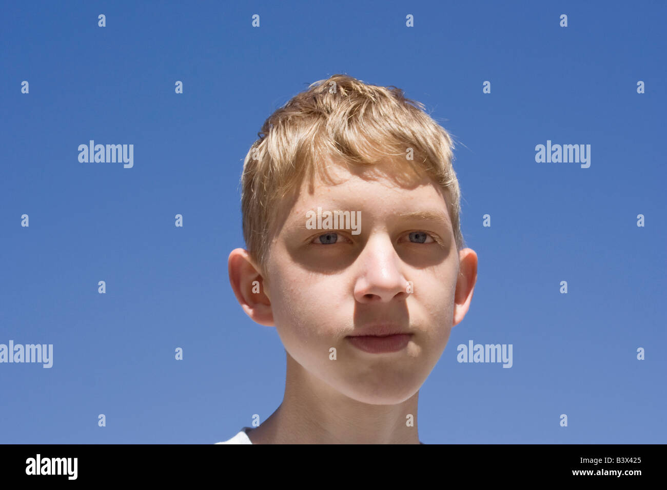 teenage boy portrait against a blue sky Stock Photo - Alamy