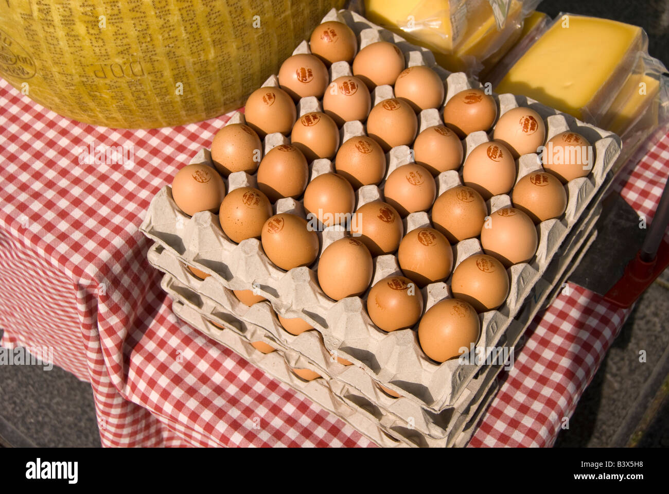 Egg crates and wrapped cheese at a market Stock Photo