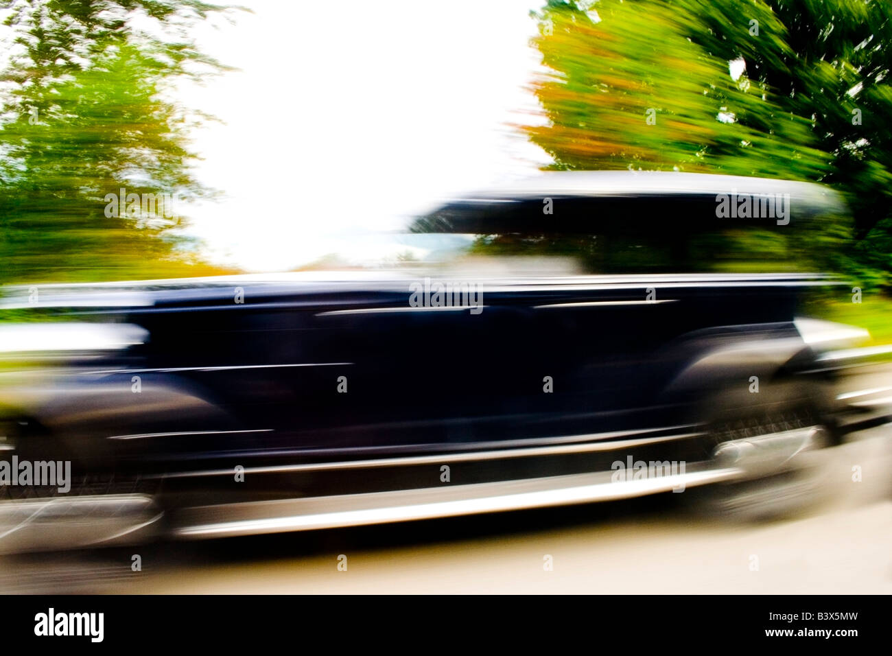 Motion blurred image of a speeding classic car Stock Photo
