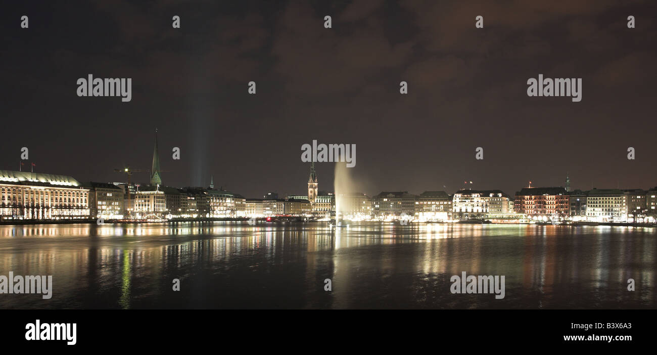 Hamburg city nights in Germany on the edge of the lake Alster with reflections Stock Photo