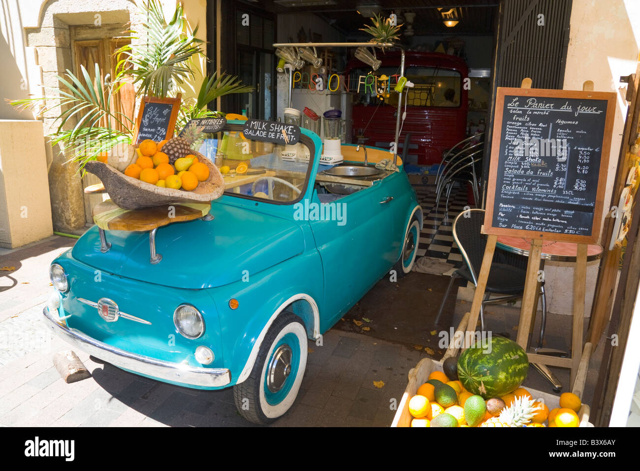 A fruit and vegetable seller uses a Fiat 500 car as a decoration for his shop in Collioure / Southern France Stock Photo