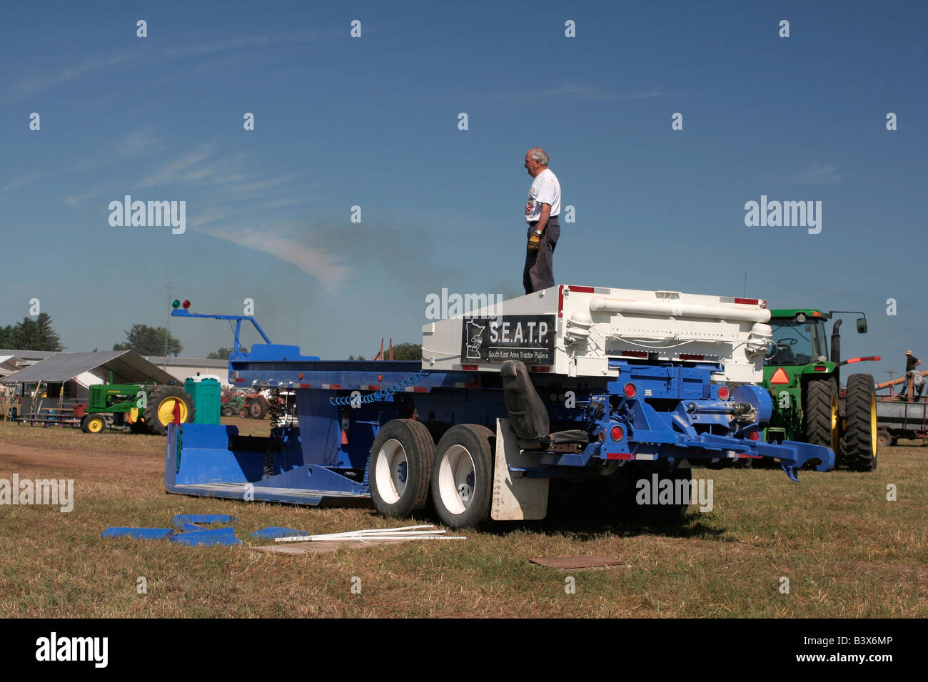 Tractor pull sled weight moves forward as it is pulled further
