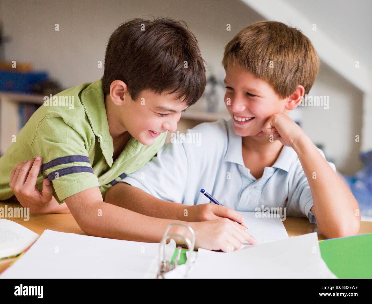 Two Young Boys Doing Their Homework Together Stock Photo - Alamy