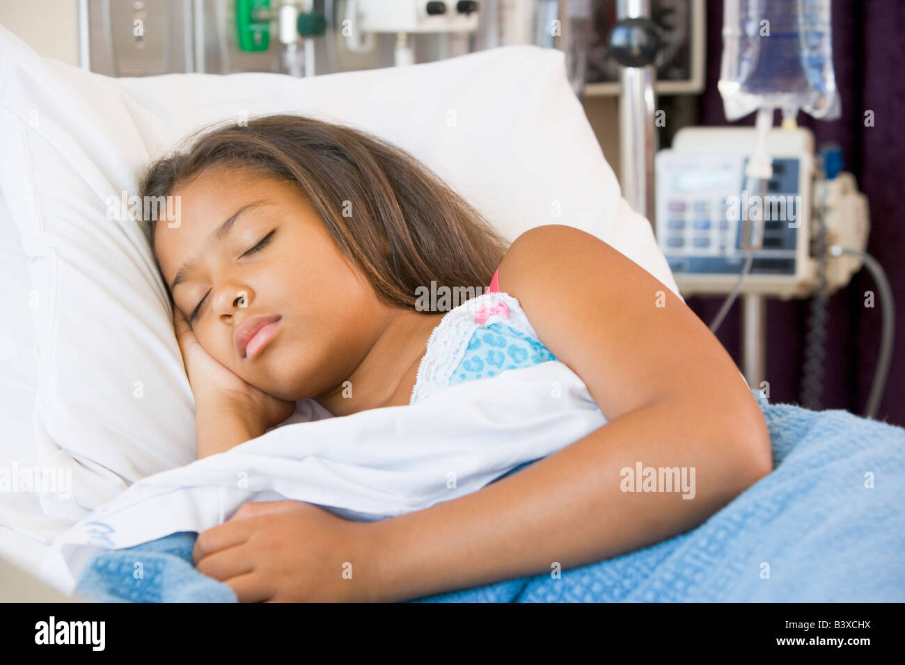 Young Girl Sleeping In Hospital Bed Stock Photo