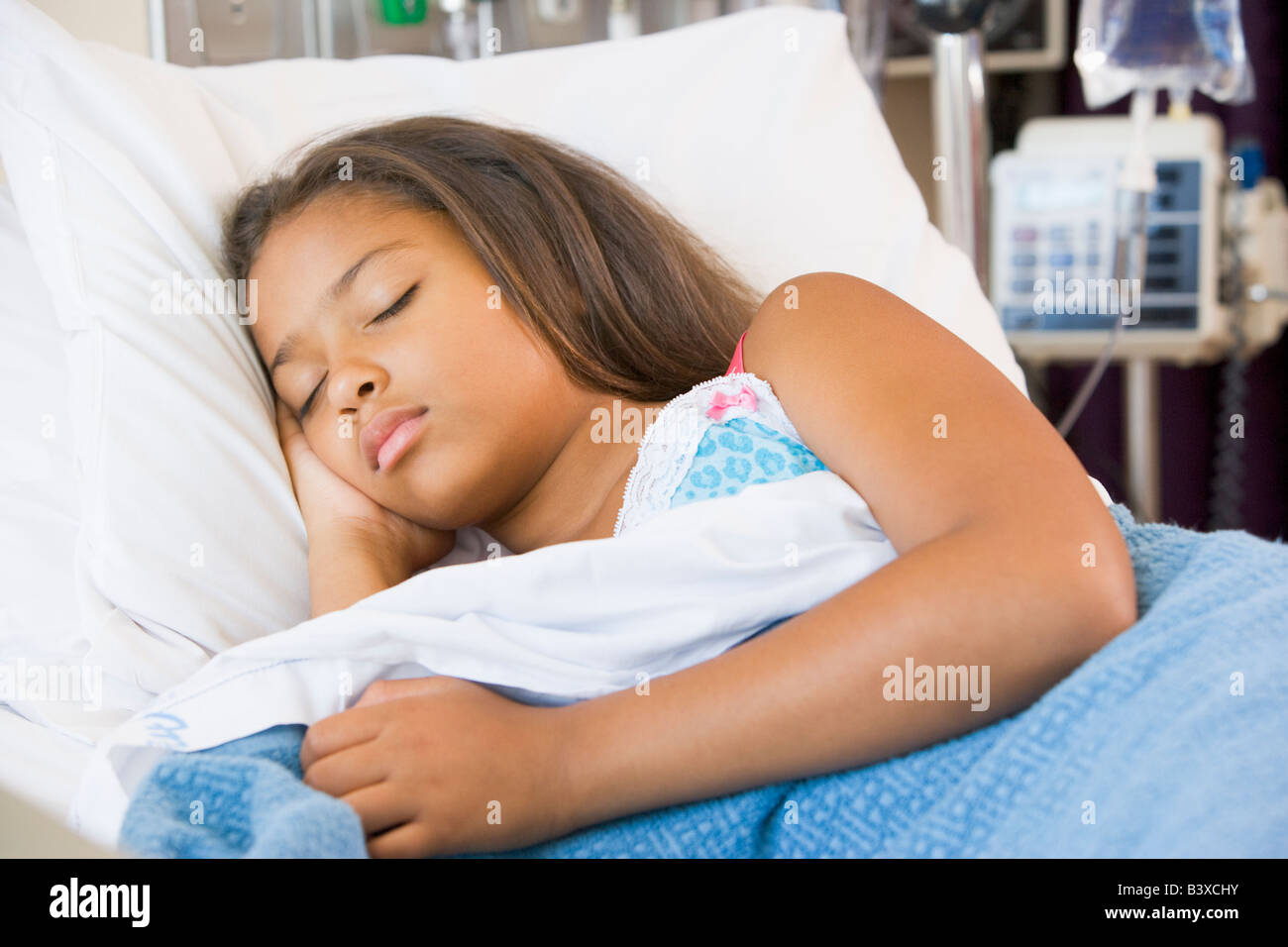 Young Girl Sleeping In Hospital Bed Stock Photo