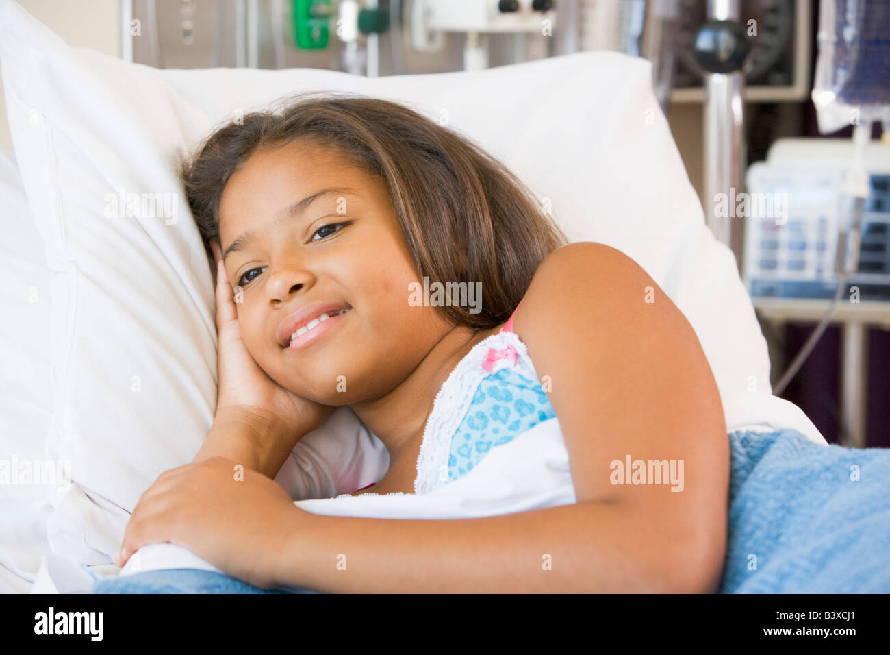 Young Girl Lying Down In Hospital Bed Stock Photo