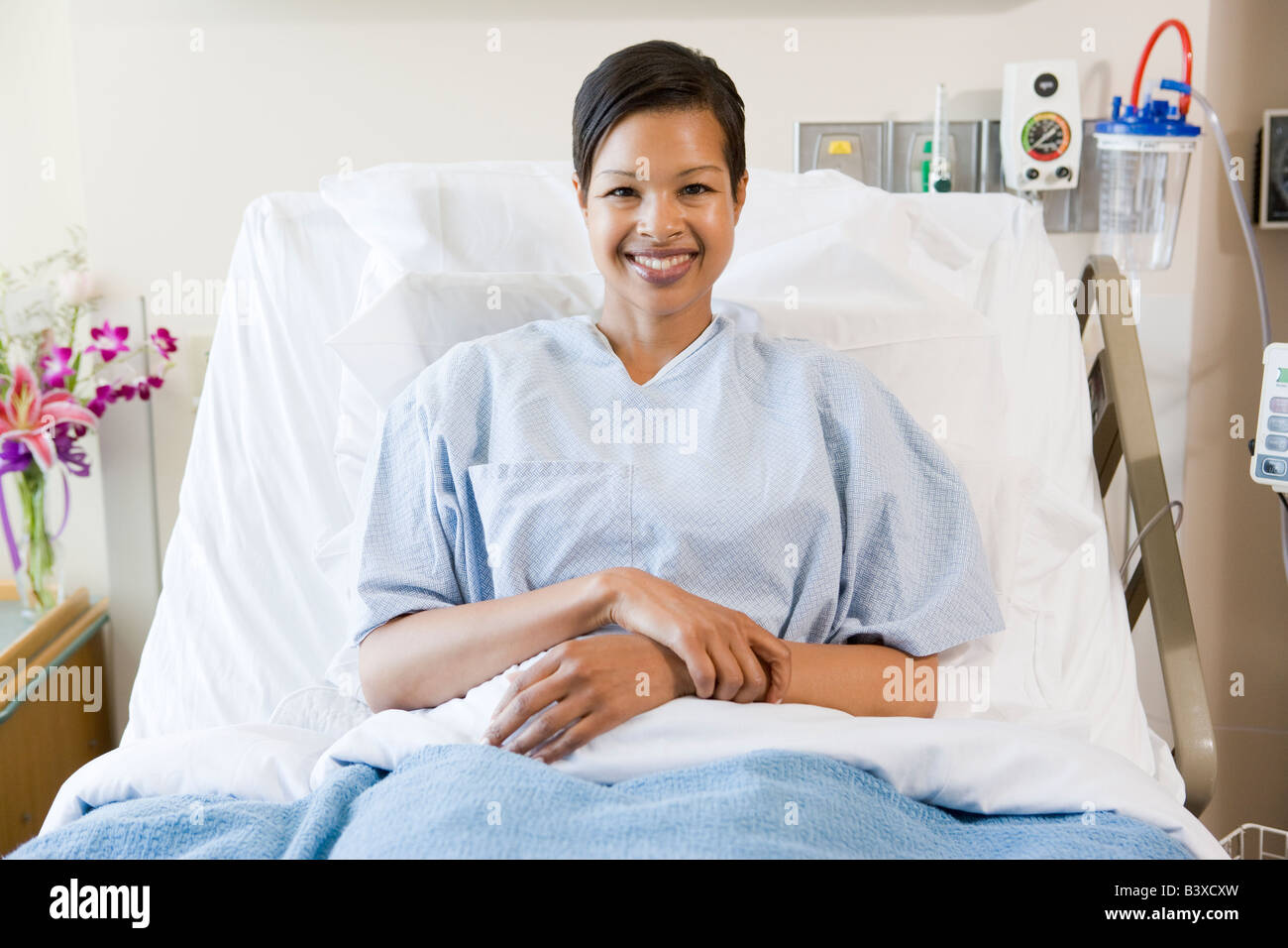 Woman Sitting In Hospital Bed Stock Photo