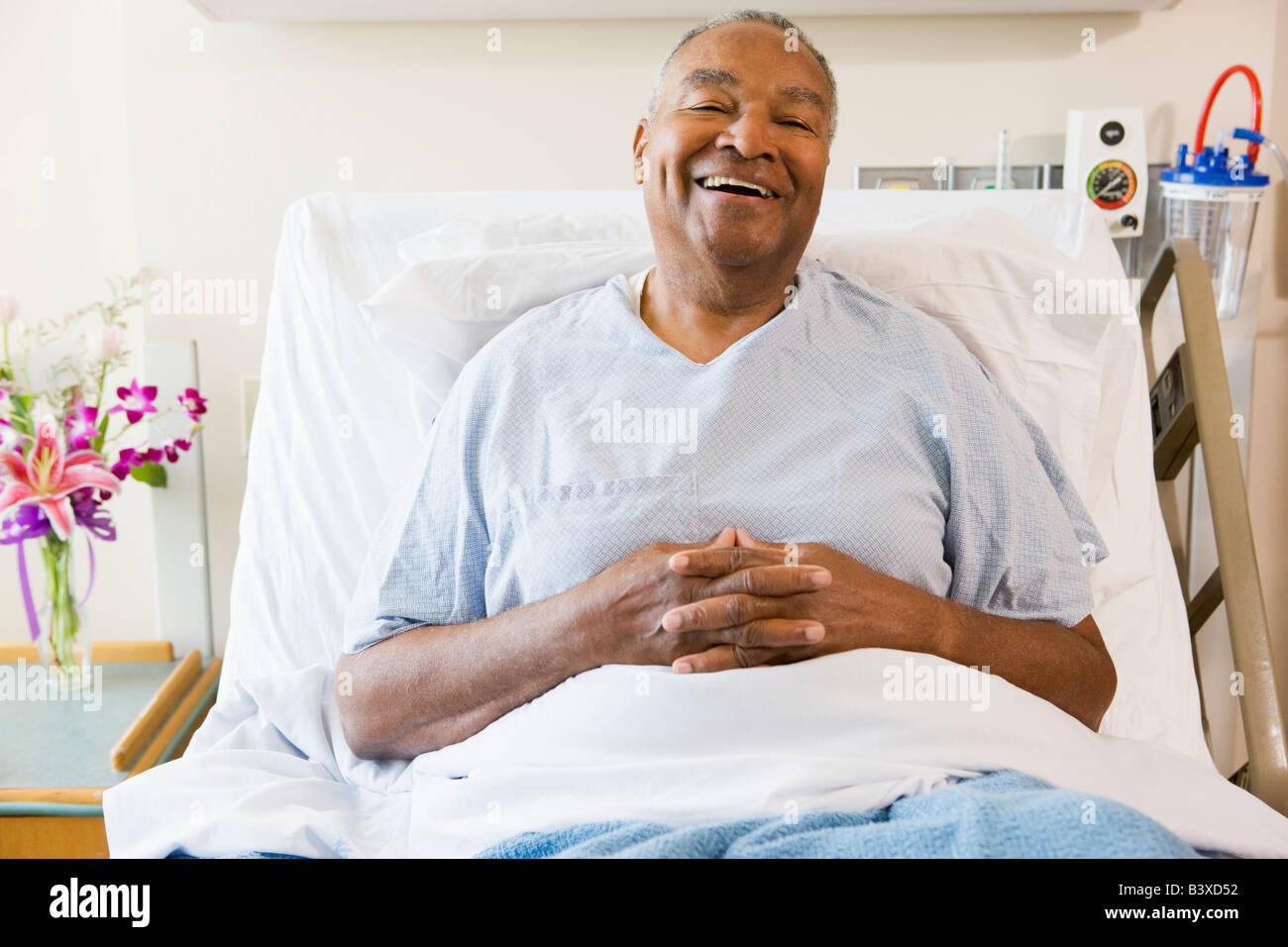 Senior Man Sitting In Hospital Bed, Smiling Stock Photo - Alamy