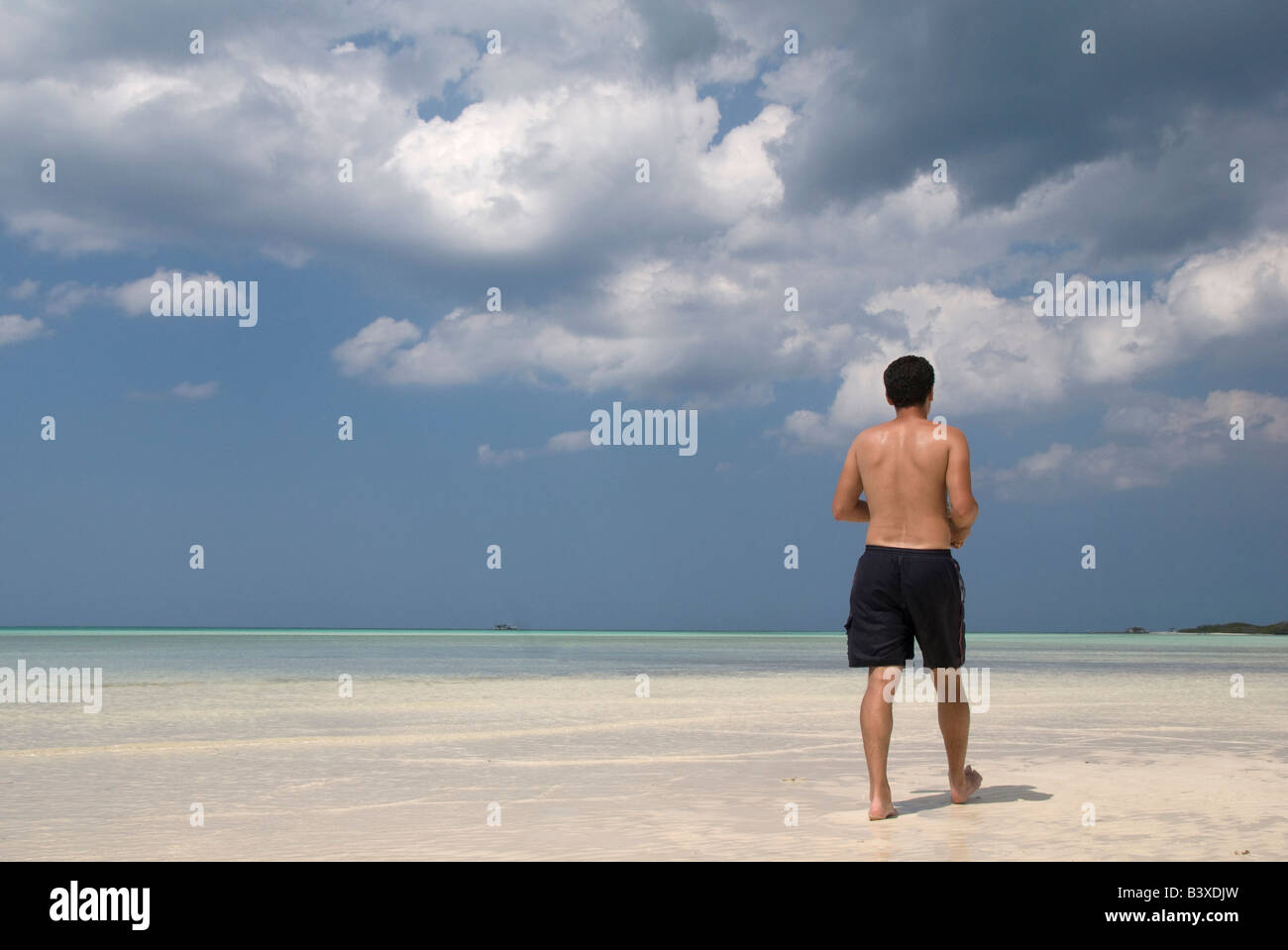 Man walking on caribbean beach hi-res stock photography and images - Alamy