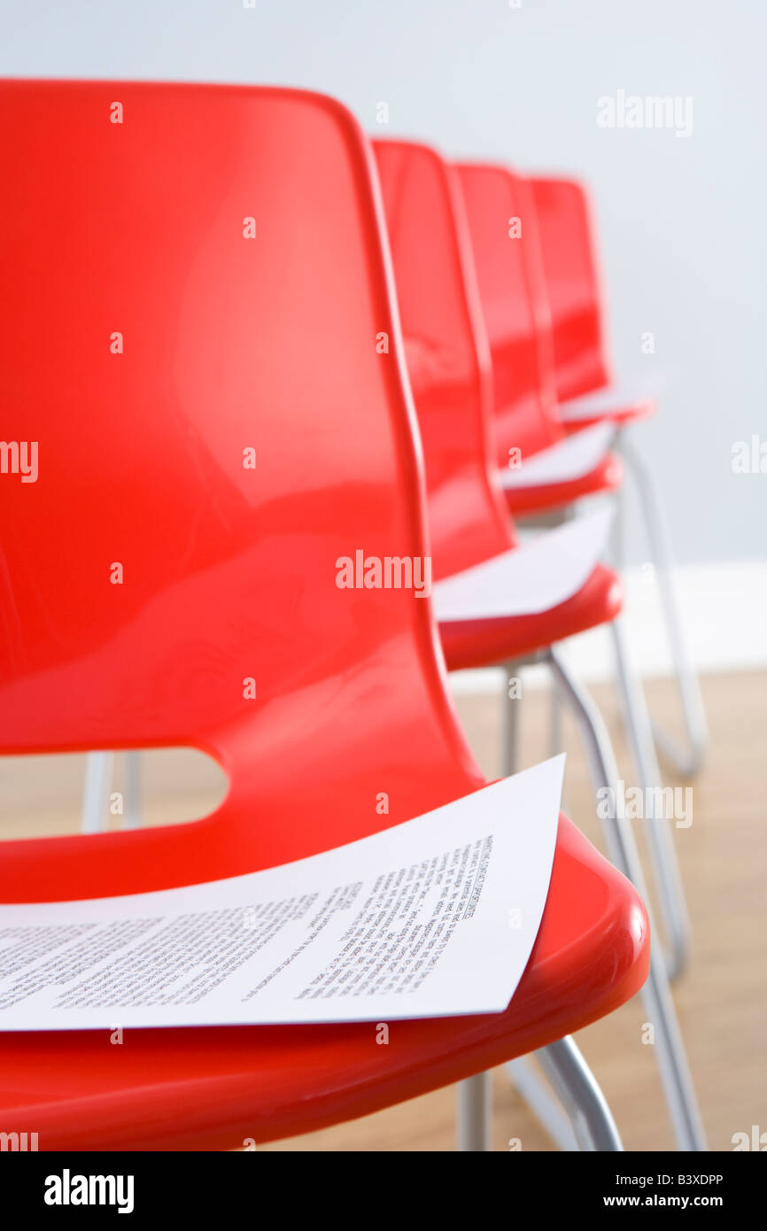 Row Of Chairs With Documents Stock Photo
