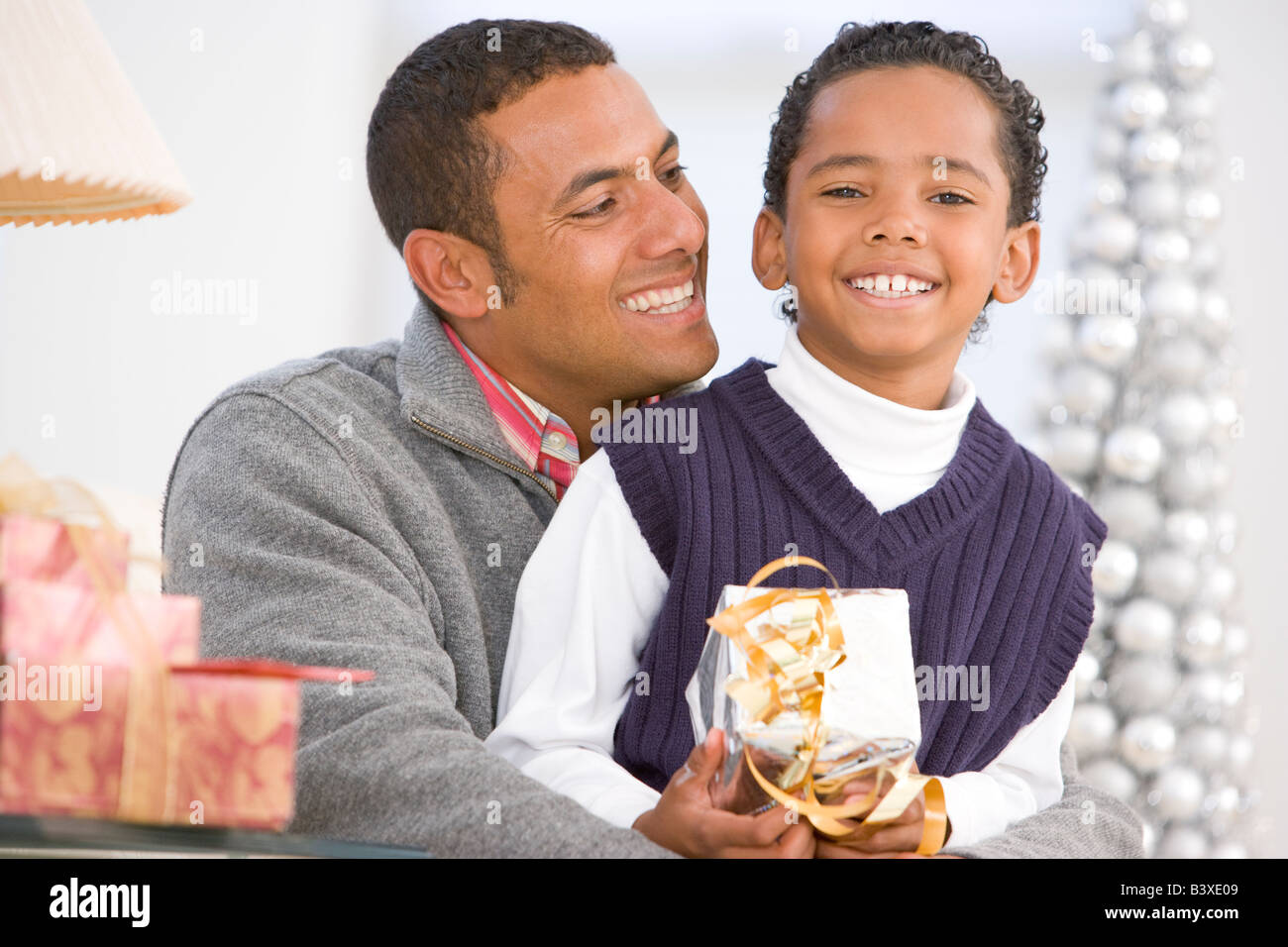 Father And Son Hugging, Holding Christmas Gift Stock Photo