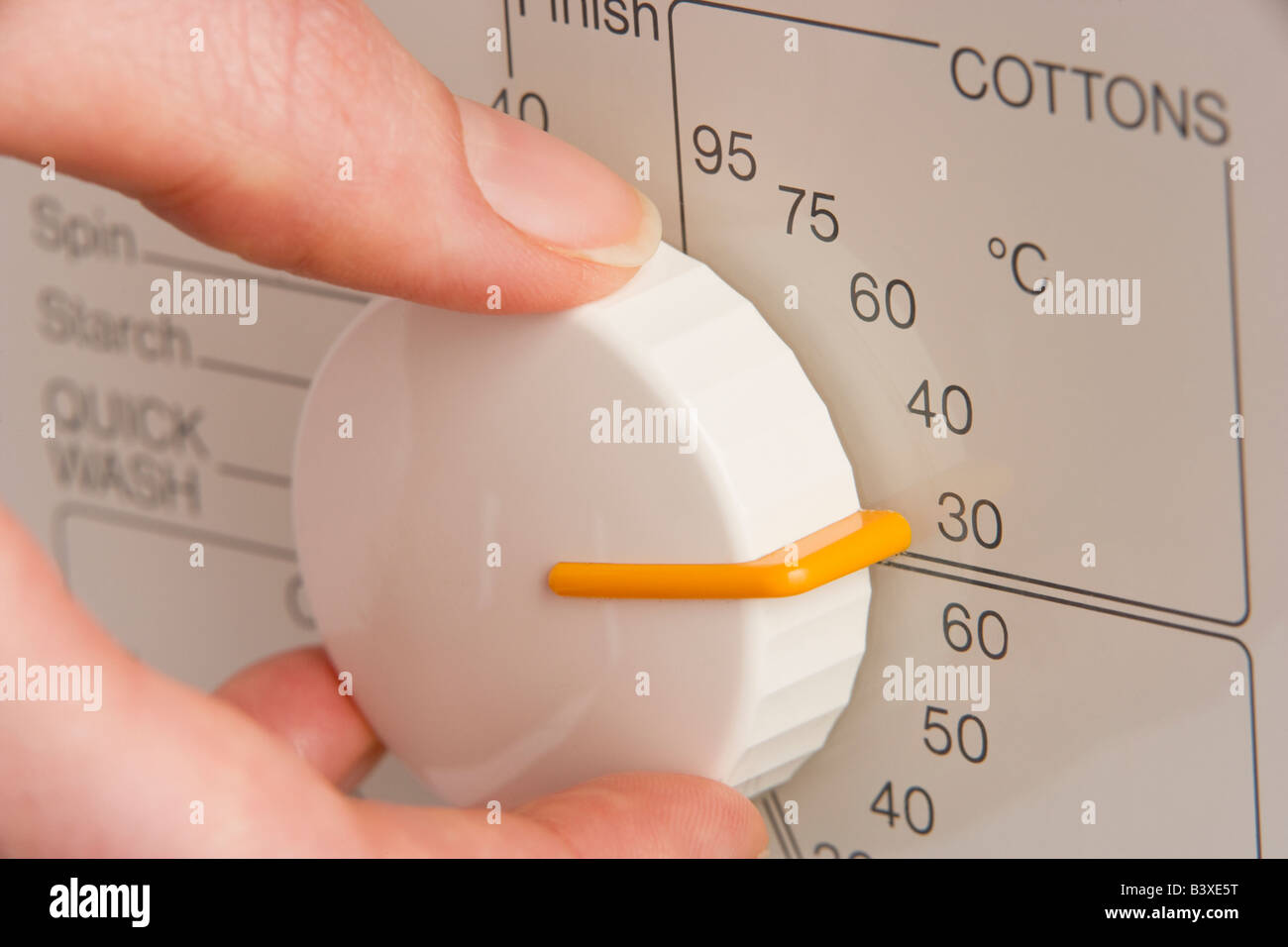 Person Adjusting Washing Machine Dial To Cold Wash Stock Photo Alamy