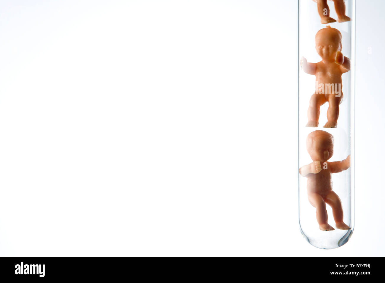 Plastic Babies In A Test Tube Stock Photo