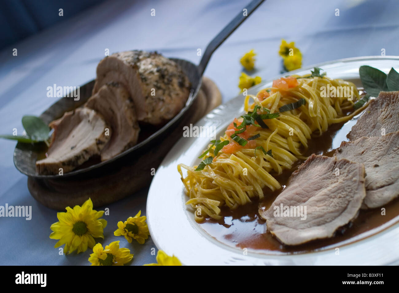 meal meat joint noodles sauce vegetable vine white flower yellow Stock Photo