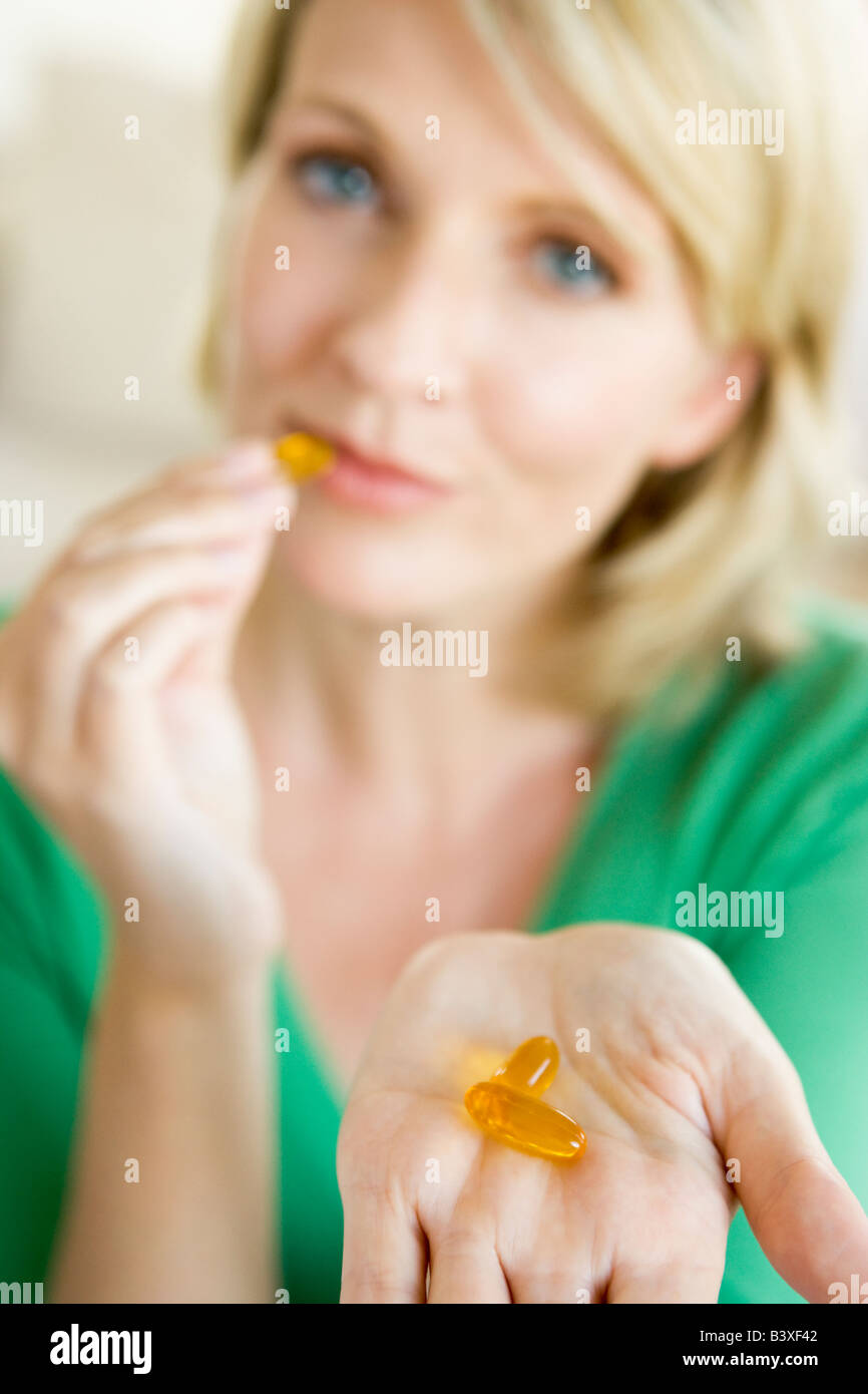 Woman Taking Pills Stock Photo