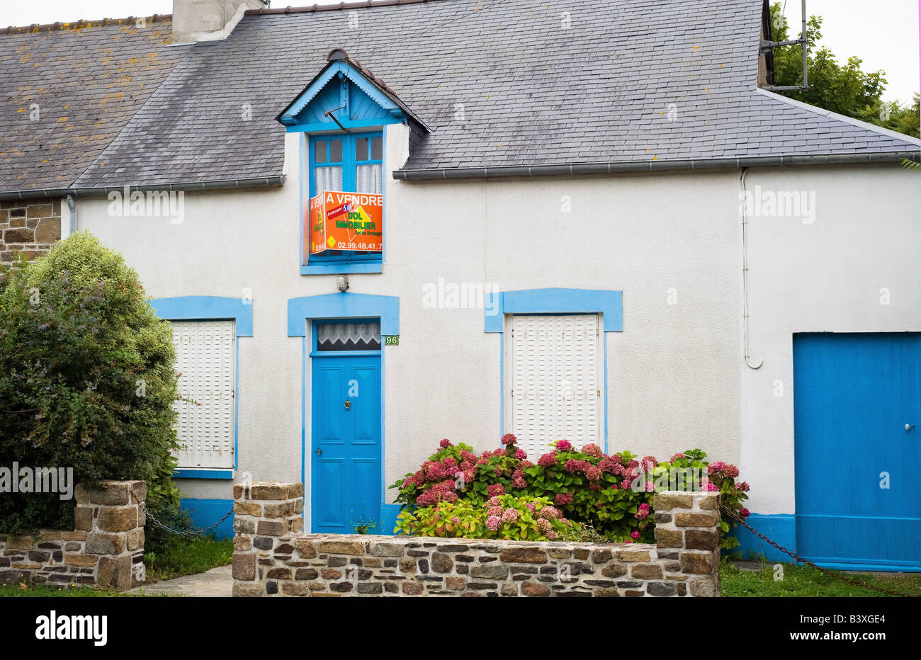 House With Blue Windows And Doors For Sale Brittany France Stock