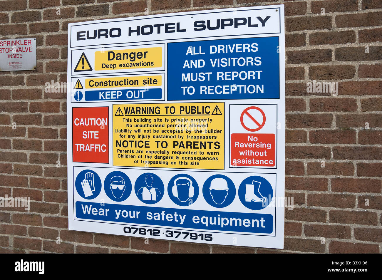 Entrance to construction site health and safety regulations warning sign on brick wall England UK United Kingdom Great Britain Stock Photo