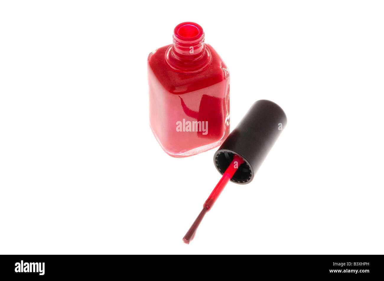 Red nail polish and brush on white Stock Photo