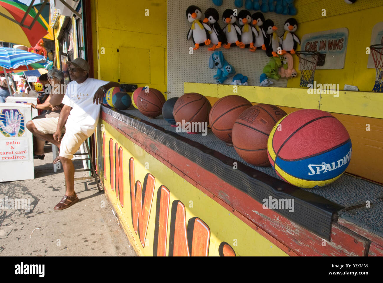 Vendor waiting for customers at a hoop game at the Coney Island amusement park Stock Photo