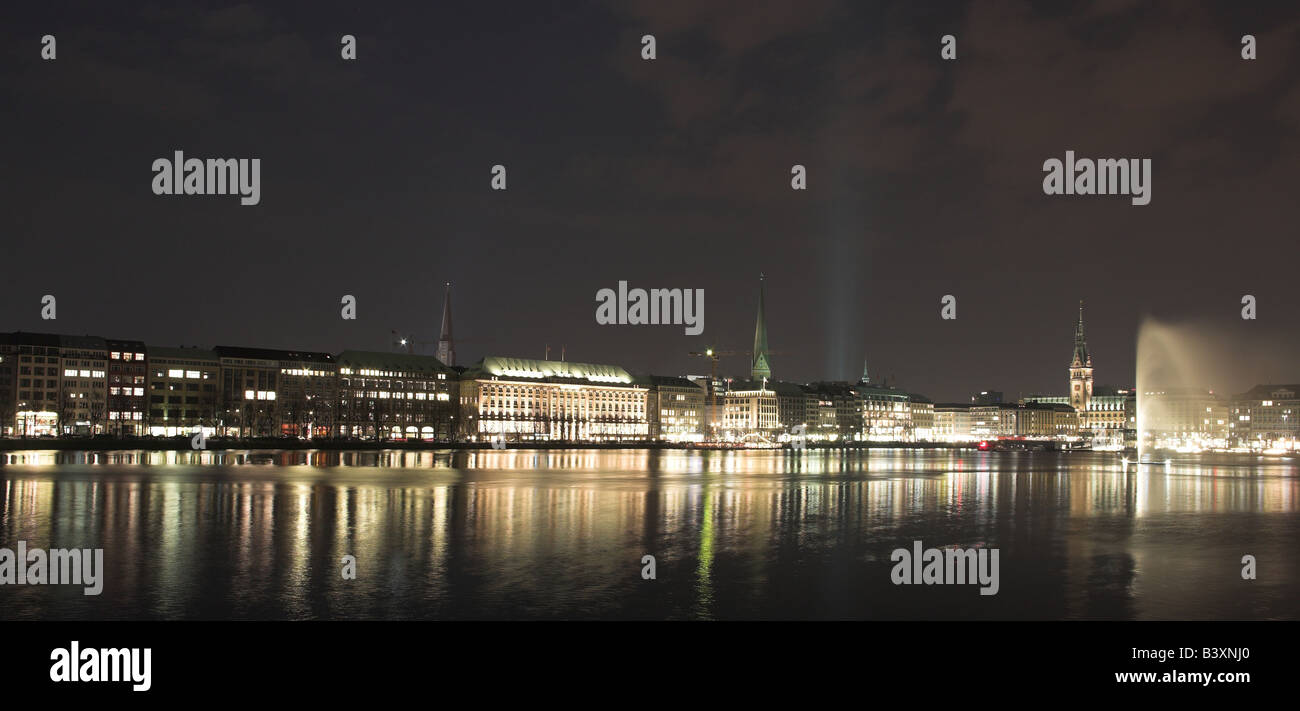 Hamburg city nights in Germany on the edge of the lake Alster with reflections Stock Photo