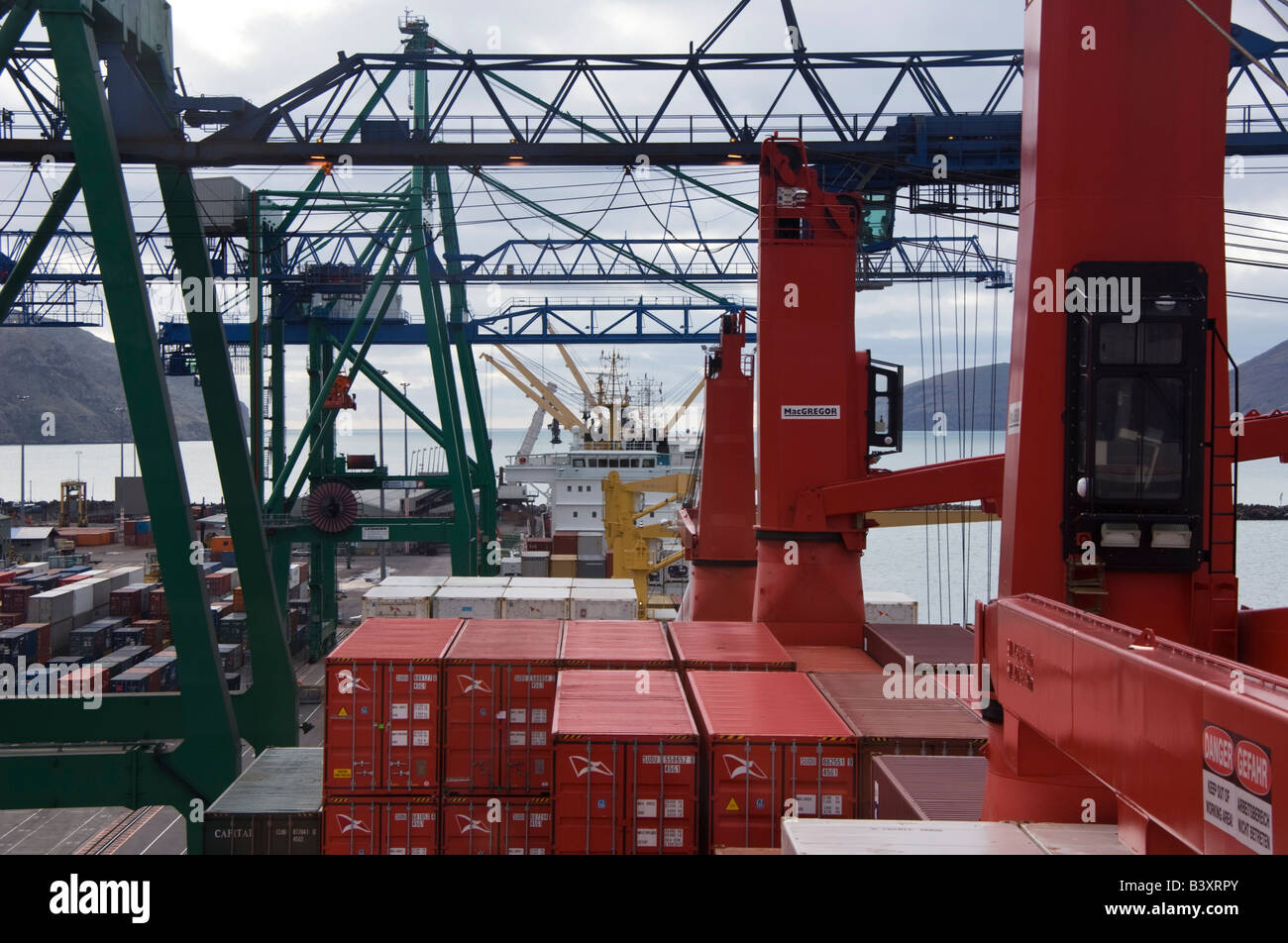 Ships and cranes at a container terminal as seen from the bridge of a container ship. Stock Photo