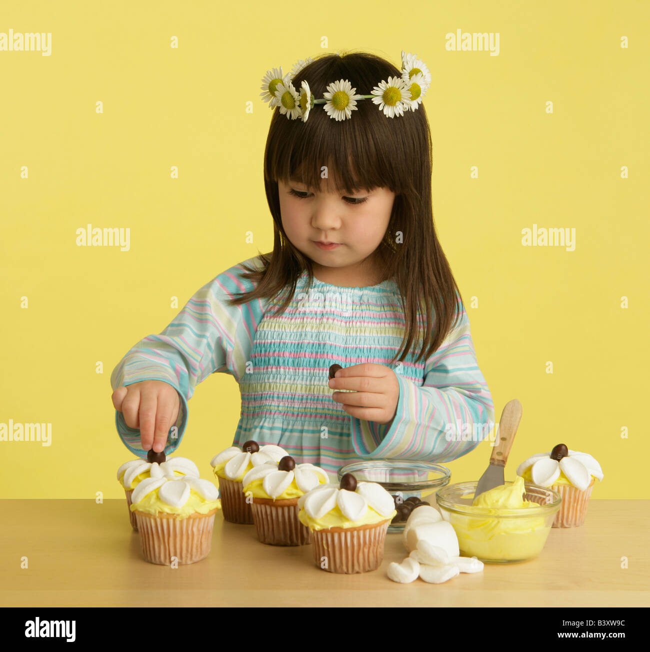 Little girl decorating cupcakes Stock Photo Alamy