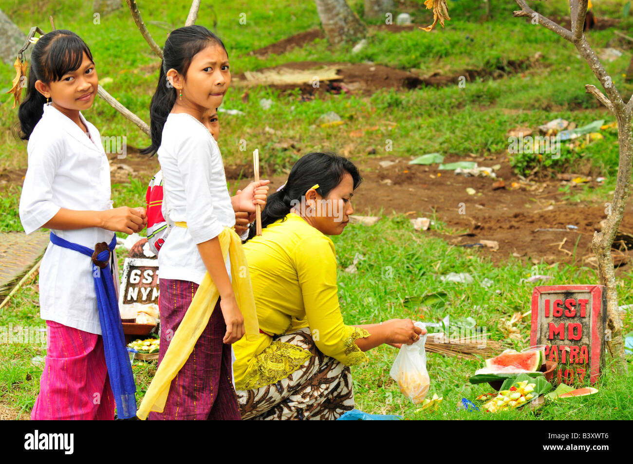 Women laying down Offerings , Temple Festival (Odalan),mengwi, Bali, Indonesia Stock Photo