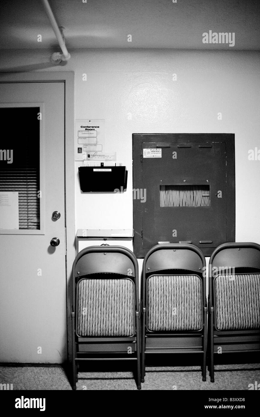 Folding chairs lined up against a wall Stock Photo Alamy