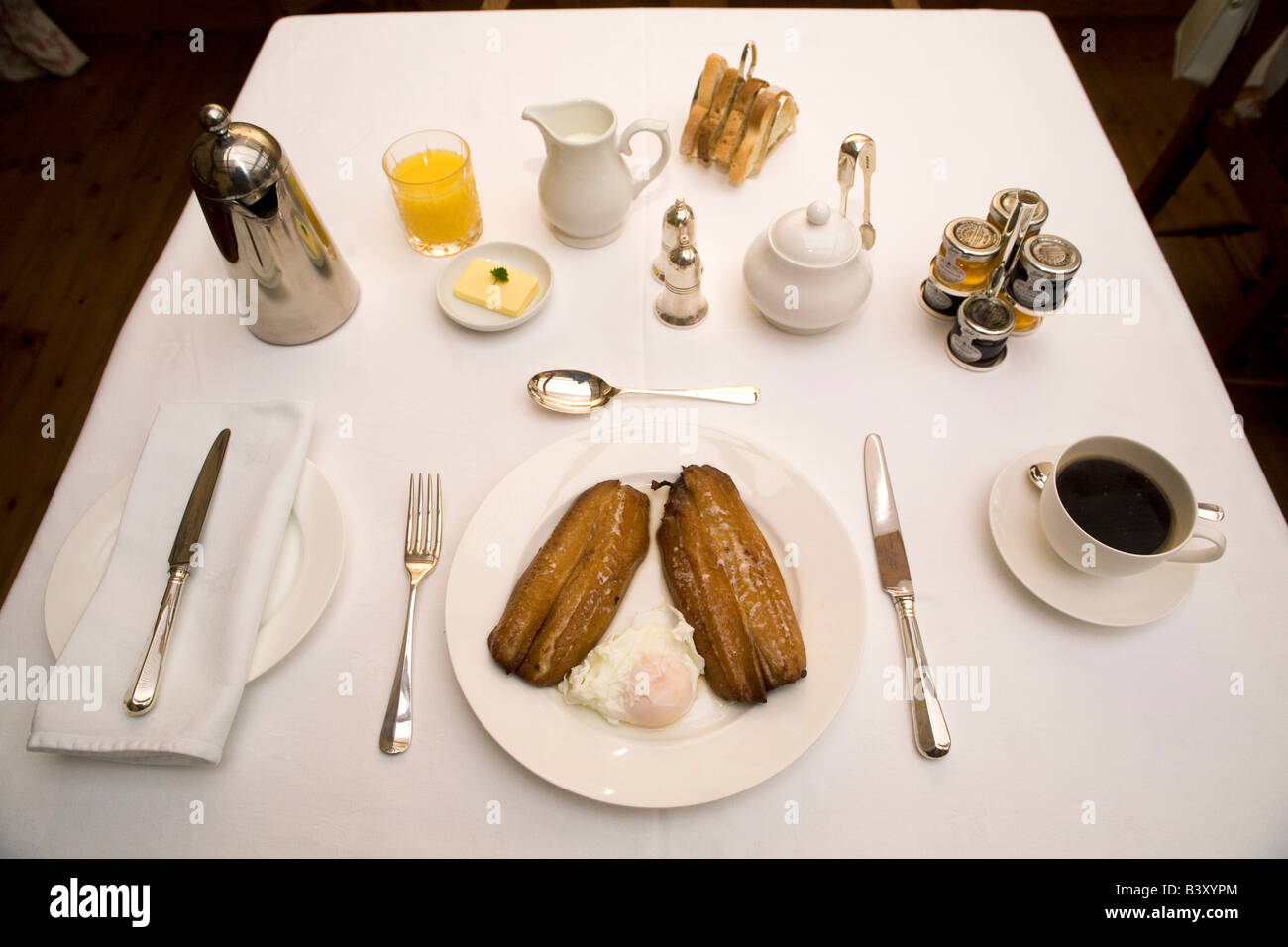 A breakfast of Craster kippers, coffee orange, juice and toast. This is one of the local specialities of Northumbrian cuisine. Stock Photo