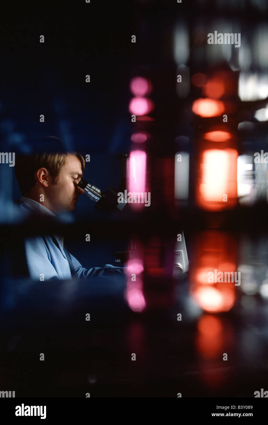 Technician checking water samples through a microscope in the quality