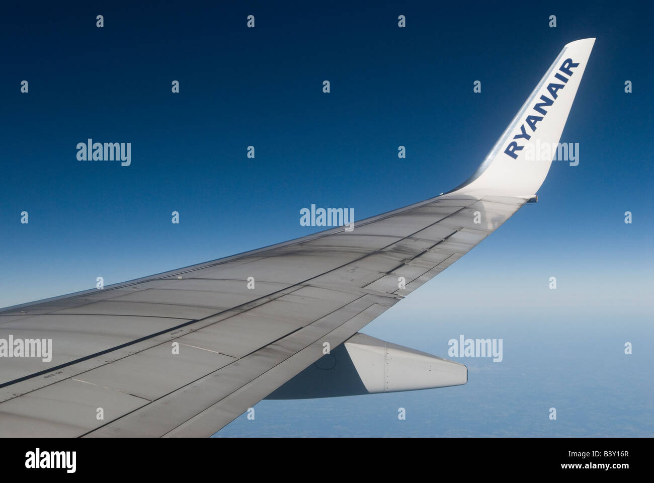 Ryanair Ryan Air wing logo of an Boeing aeroplane looking out of window above cloud level Blue sky 2008 2000s HOMER SYKES Stock Photo