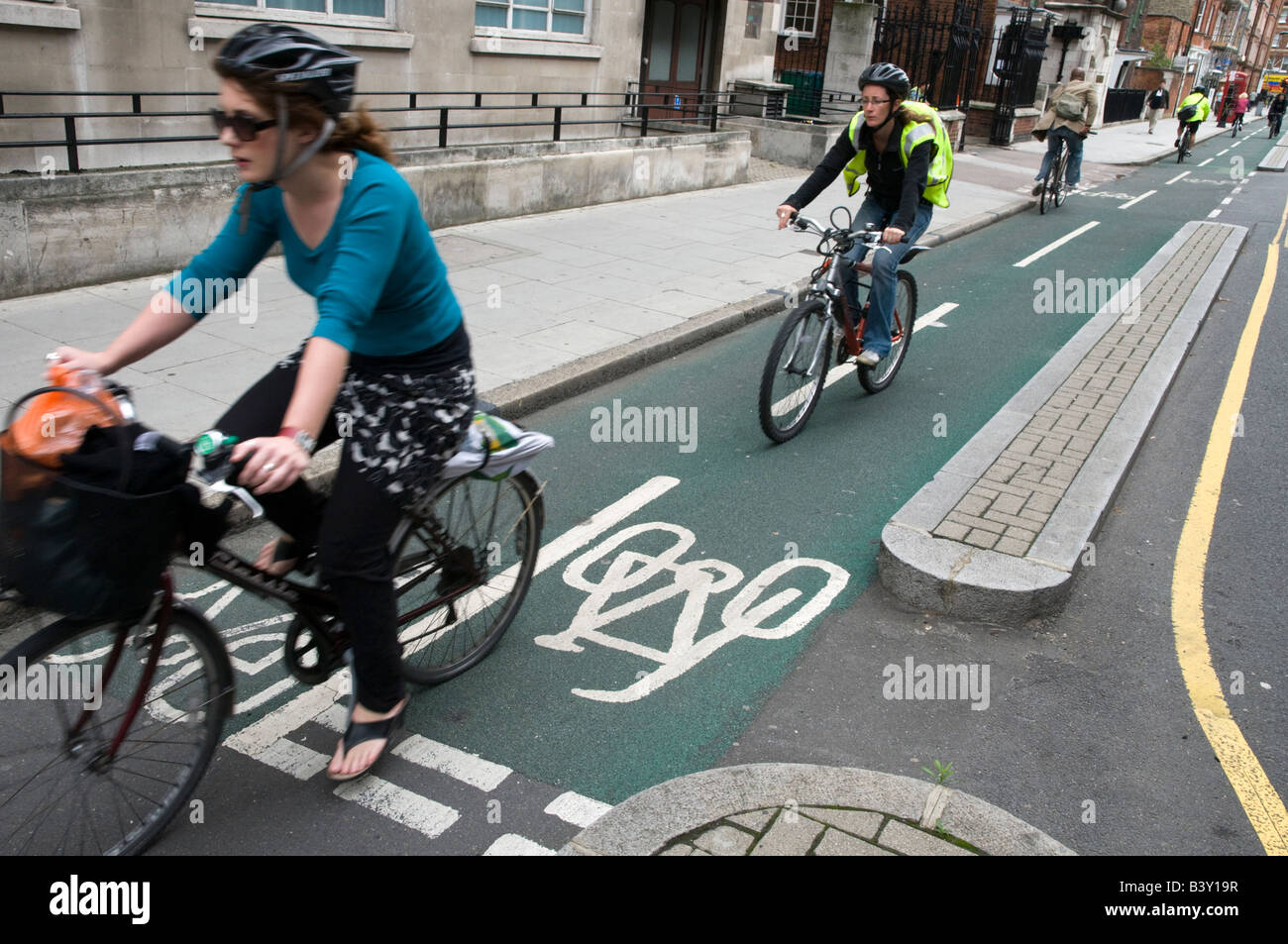 Cyclists riding in segregated cycling lane, London, England, UK Stock Photo