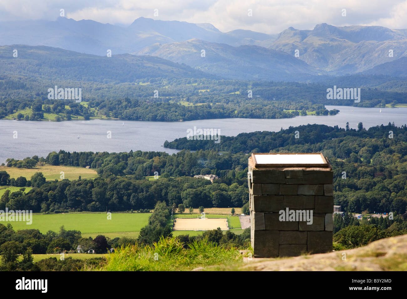 Scenic view over Windermere Lake towards langdale from Orrest Head. Viewpoint and bench in foreground. Stock Photo