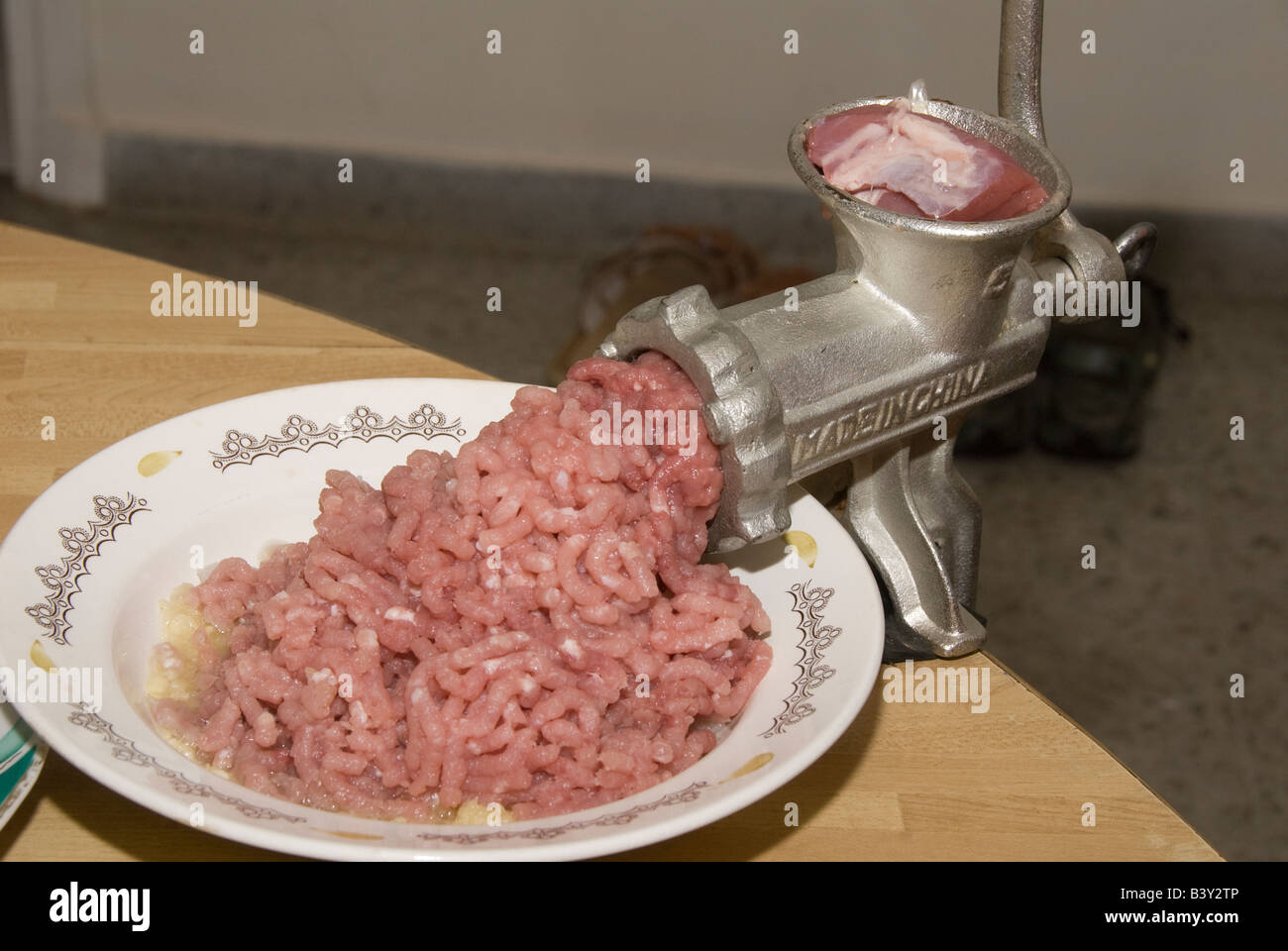 meat and grinder. Minced meat and meat grinder. Meat grinder machine  chopping uncooked ground meat Stock Photo - Alamy