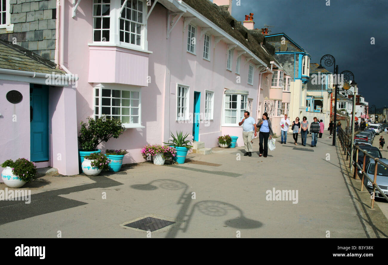 Eating ice cream on the main promenade with its ammonite design lamp posts in Lyme Regis, Dorset, England. Stock Photo