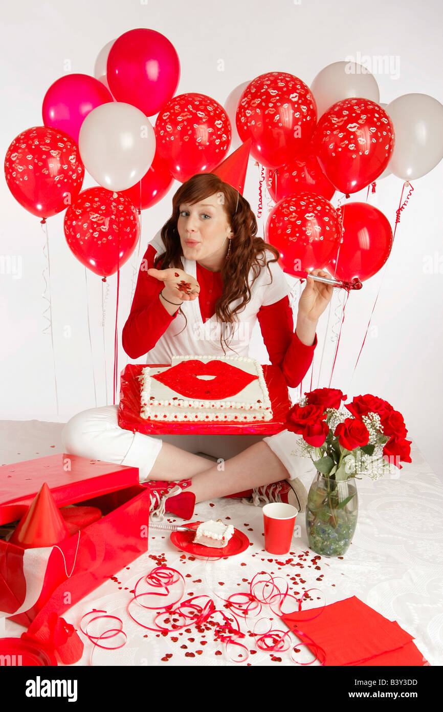 Lady with red balloon's and a cake Stock Photo